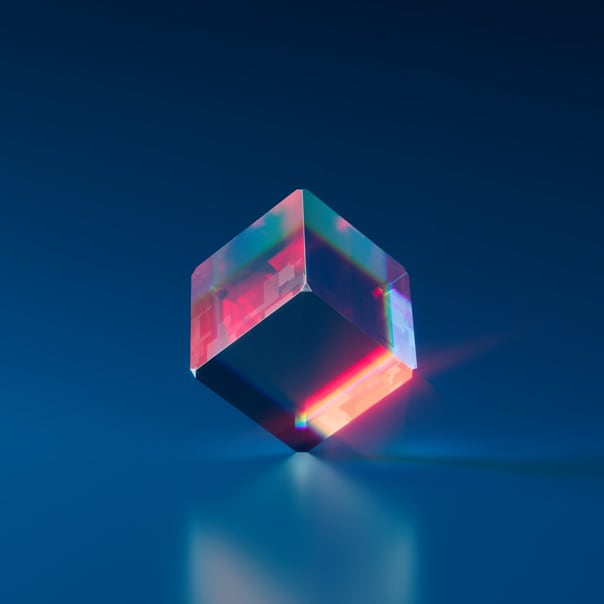 Shining cube standing on a glassy floor